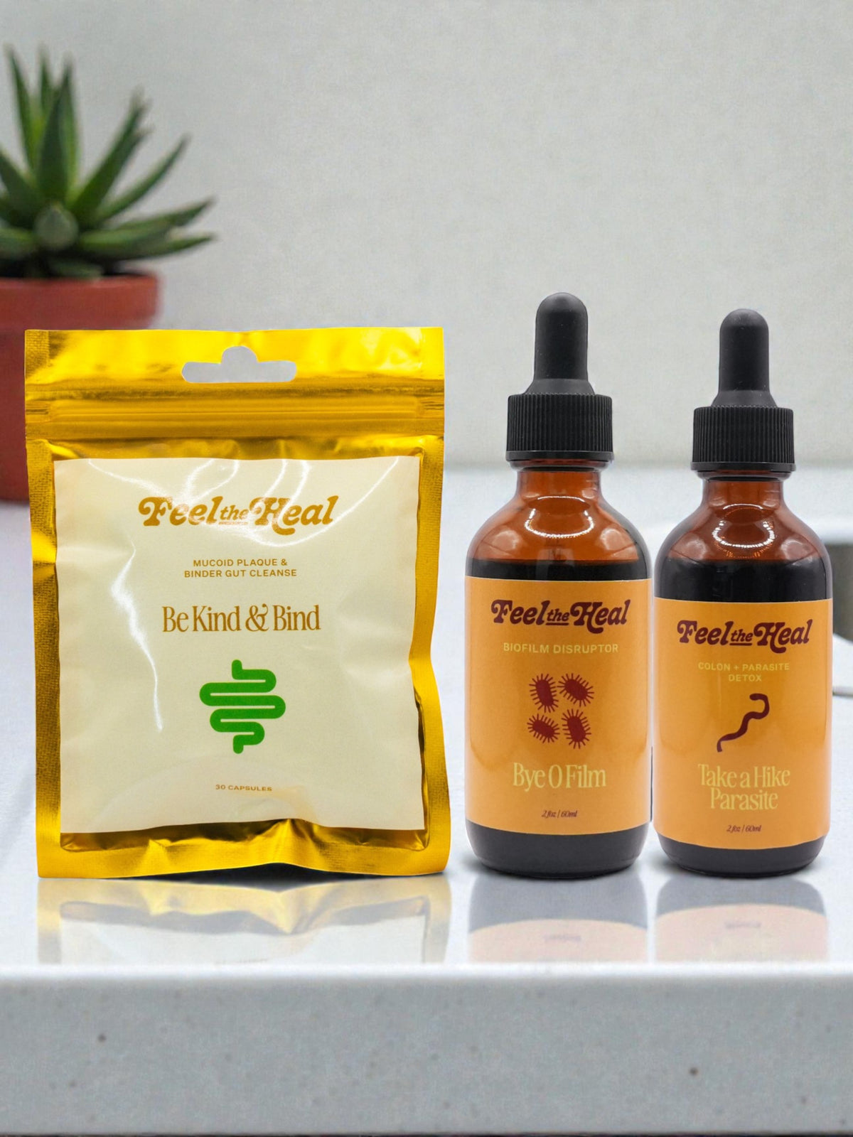 Two bottles of 'Feel Hea' with a yellow package on a white surface.