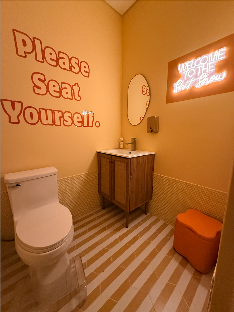 Bathroom interior with humorous signs on the wall.