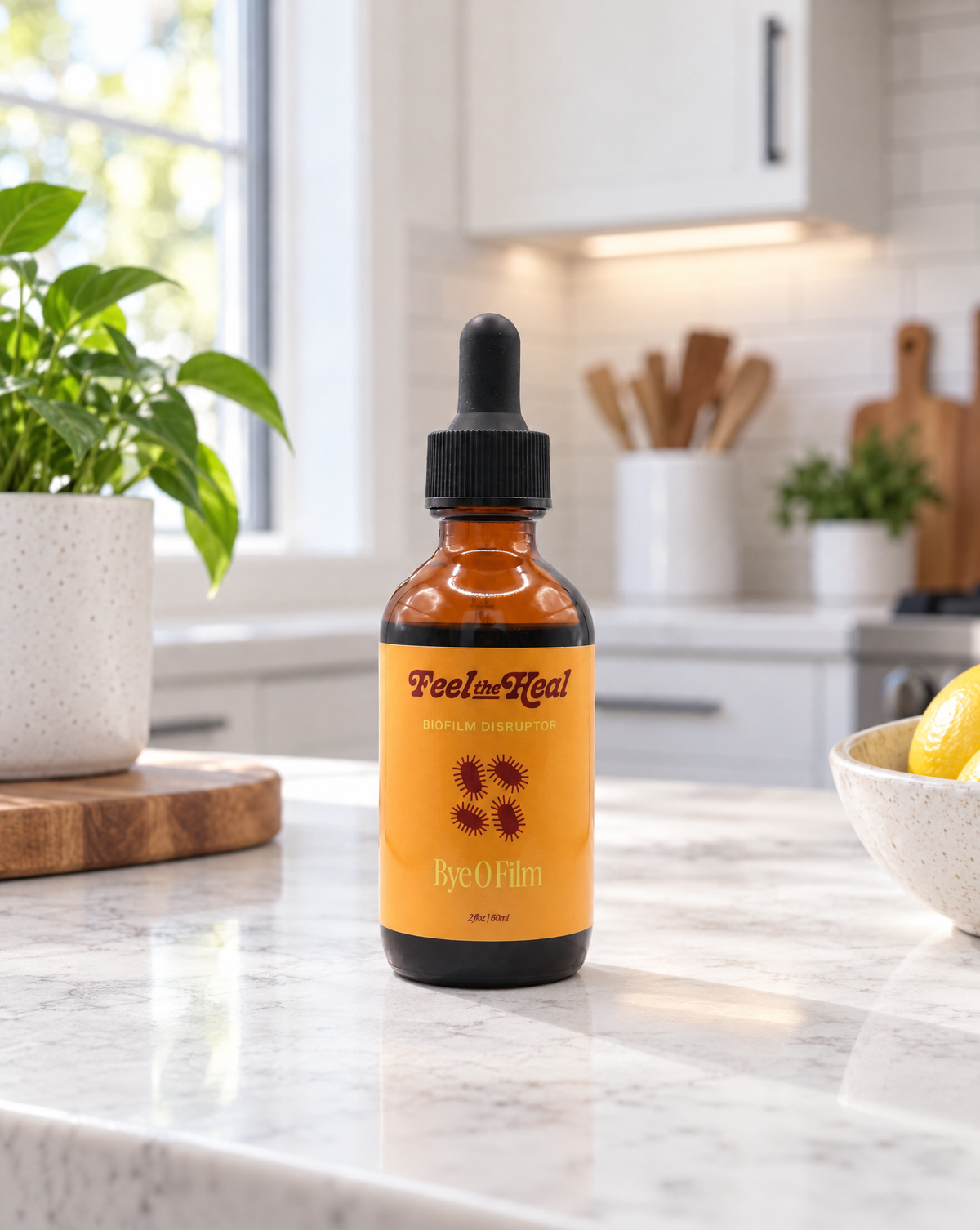 An amber glass dropper bottle labeled 'Peel the Heal' and 'Bye O Film' sits on a white marble kitchen counter with a blurred modern kitchen in the background.