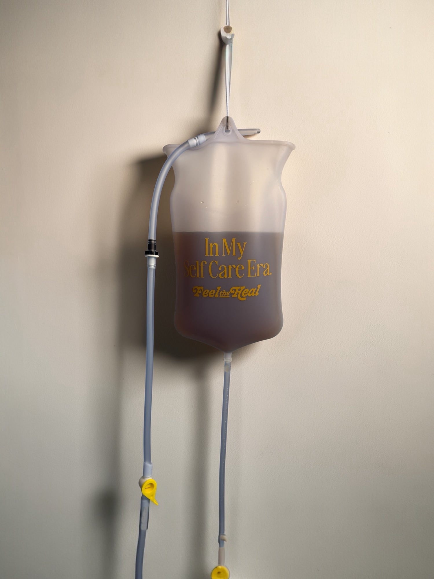 IV bag with 'In My Care Era' text on a beige background coffee enema
