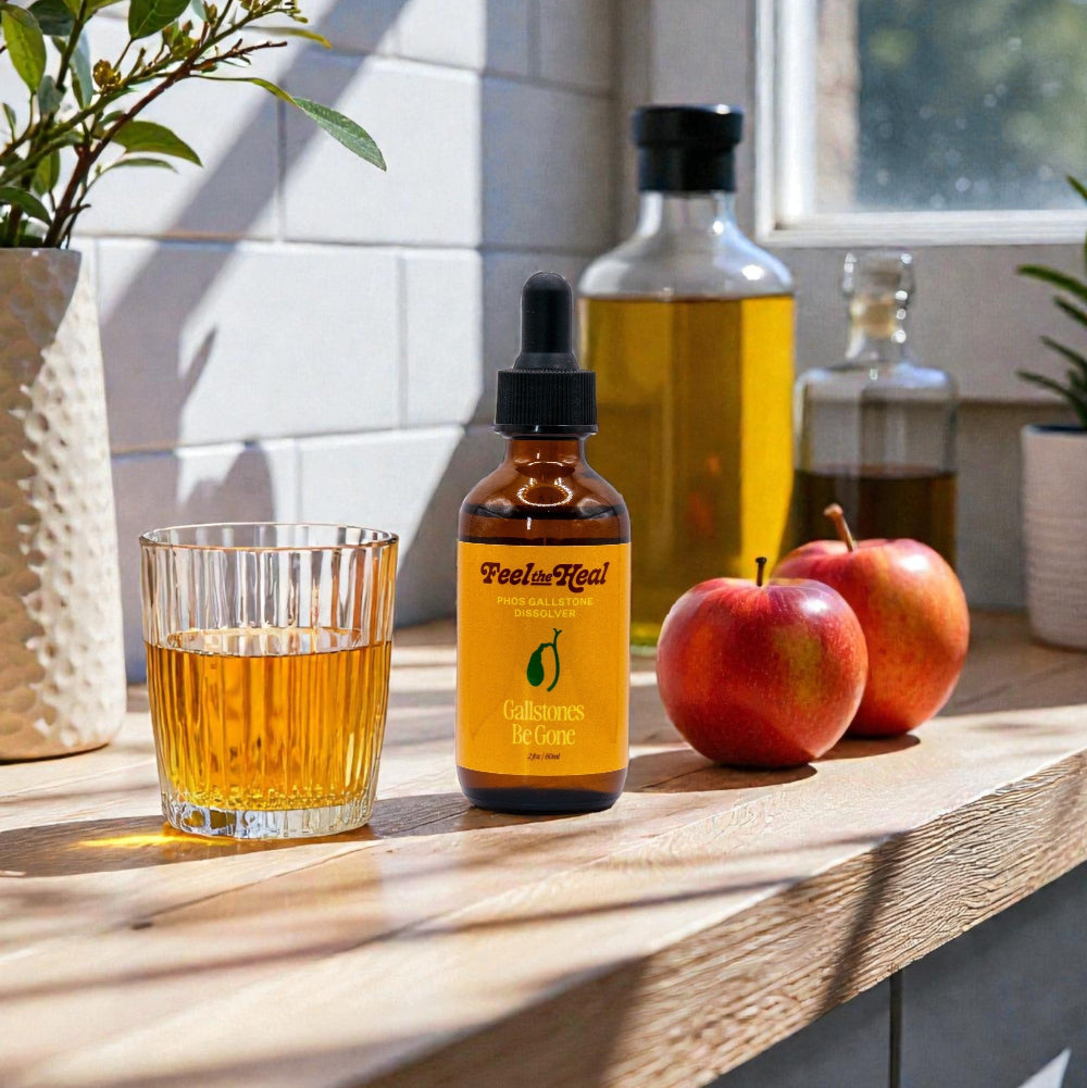 Bottle of 'Feels Real' Gummies on a wooden surface with a glass of amber liquid and apples.liver and gallblader cleanse phos 30 drops