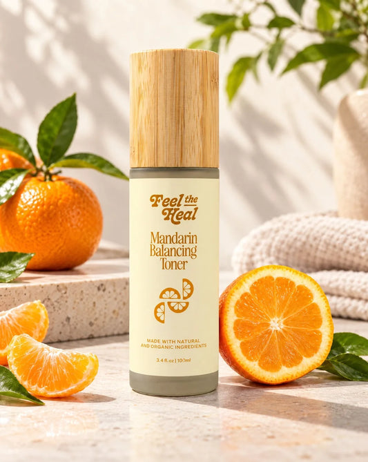 Mandarin Balancing Toner by Feel the heal, featuring a bamboo cap and cream-colored bottle, styled with fresh mandarin oranges on a marble surface.
