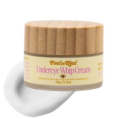 Jar of 'Feel the Heal' undereye whip cream with a wooden lid on a white background
